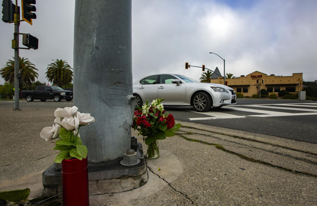 A car turns right from Verano Avenue onto Highway 12, next to a small memorial where Julio Estrada, 36, was fatally injured. Photo taken on Wednesday, Jan. 18, 2023. (Robbi Pengelly/Index-Tribune)