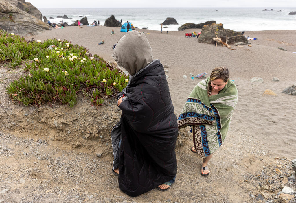 Debbie Bliem of Laytonvville, right, and her daughter Tara Spitalny of Cotati lasted about 20 minutes before packing up and leaving the cold, windy Schoolhouse Beach on the Sonoma Coastm Sunday, May 14, 2023. Soitalny said “we thought it was going to be warm, WE WERE WRONG!”  (John Burgess / The Press Democrat file)