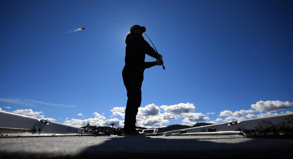 Josh Adams, 18, of Cloverdale, casts his line in to Clear Lake just offshore of incorporated Clearlake, Thursday, March 11, 2021 in Lake County.  Adams started his own business as a guide to the best fishing holes on the lake.  (Kent Porter / The Press Democrat) 2021