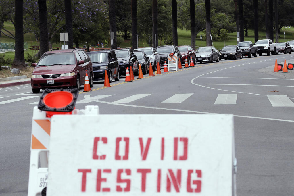 Motorists line up at a coronavirus testing site at Dodger Stadium Monday, June 29, 2020, in Los Angeles. Less than two months ago, Los Angeles had so many tests available for coronavirus that tens of thousands were going unused. Today, it’s impossible to book an appointment. The current resurgence of the virus has spiked demand in LA and across the state for tests, leading to long lines and a fear that supplies will run low and create a bottleneck in a system that has taken months to expand. (AP Photo/Marcio Jose Sanchez,File)