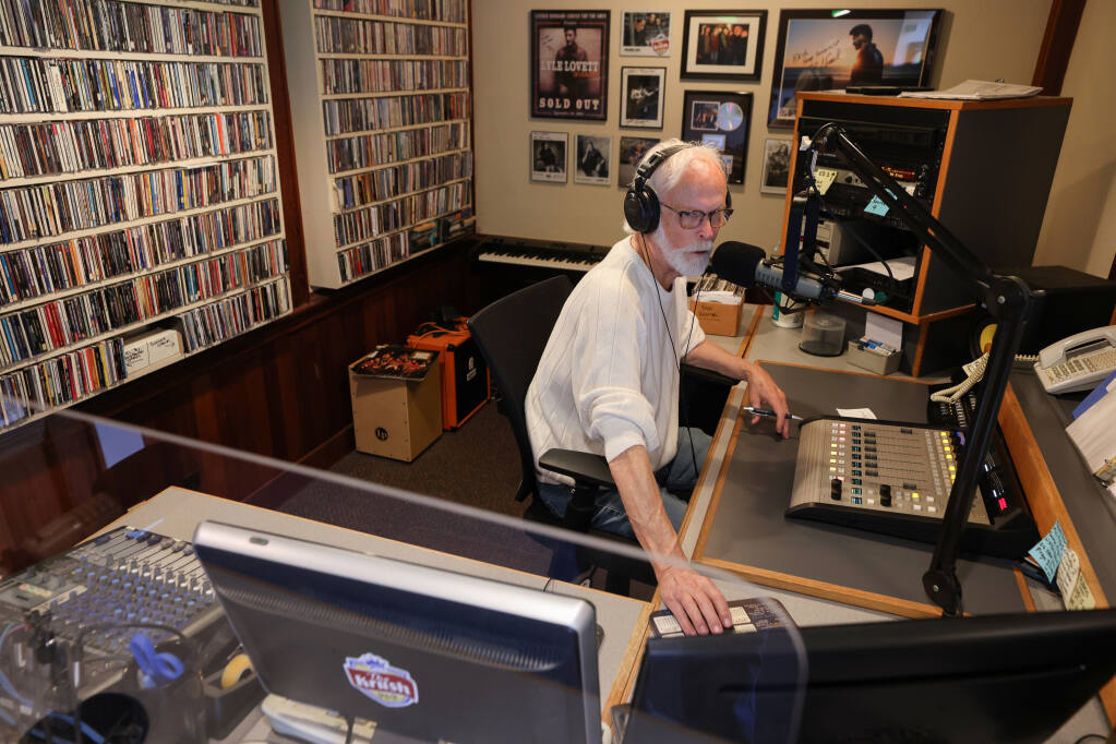 Bill Bowker runs his show at The Krush 95.9 in Santa Rosa on Wednesday, Nov. 17, 2021. Bowker will retire on Dec. 15 after 28-years at the station and a 52-year career in local radio. (Christopher Chung/ The Press Democrat)