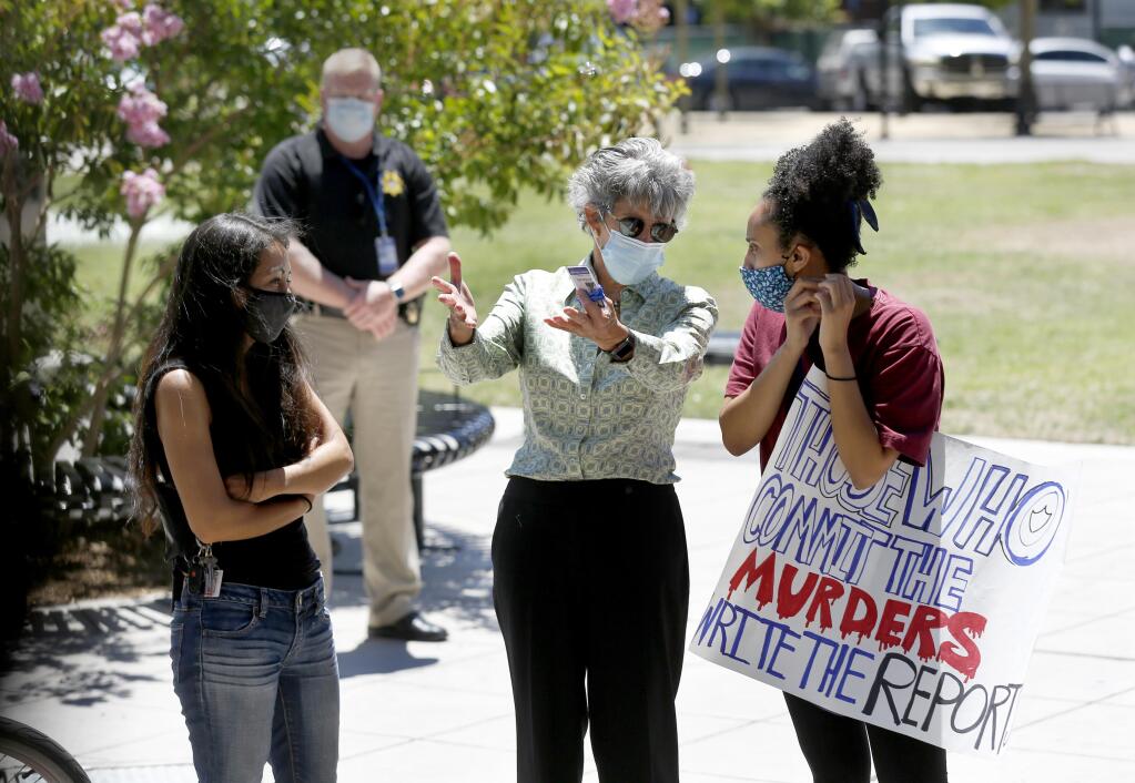Sonoma County District Attorney Jill Ravitch talks with Black Lives Matter activists Jazmin Gomez, left, and Samra Tekle, right, at Old Courthouse Square in Santa Rosa, California, on Monday, July 6, 2020. (BethSchlanker/The Press Democrat)