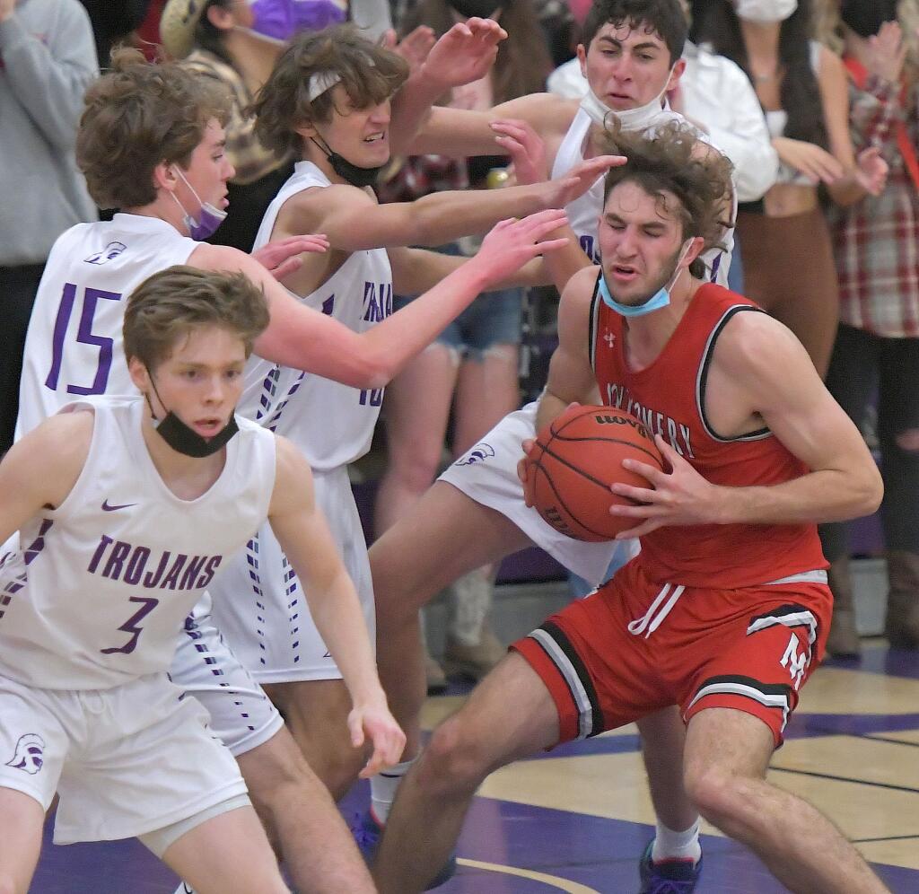 Petaluma defenders surround Montgomery’s Nolan Bessire in game won by Montgomery. Nov. 20, 2021(SUMNER FOWLER / FOR THE ARGUS-COURIER)