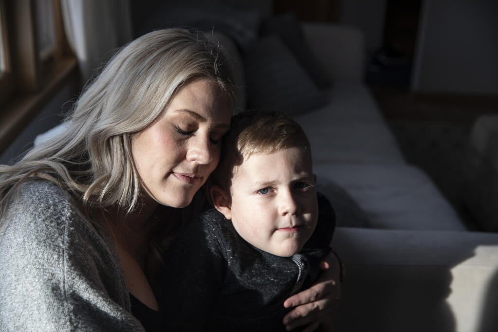 Jude Knott, 4, at home with his mother, Ashley Knott, in Omaha, Neb, on Feb. 4, 2021. Jude was hospitalized for 10 days after developing a headache, fever, vomiting, red eyes and a rapid heart rate. (Kathryn Gamble/The New York Times)
