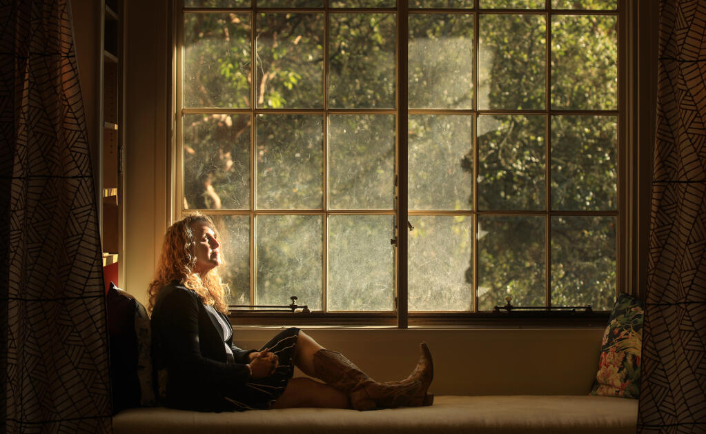 Iris Dunkel soaks in the afternoon light in a window reading nook used by Charmian London, wife of Jack London, in the House of Happy Walls at Jack London State Park, Wednesday, Oct. 21, 2020. Dunkel has written the first complete biography on Charmian. (Kent Porter / The Press Democrat)