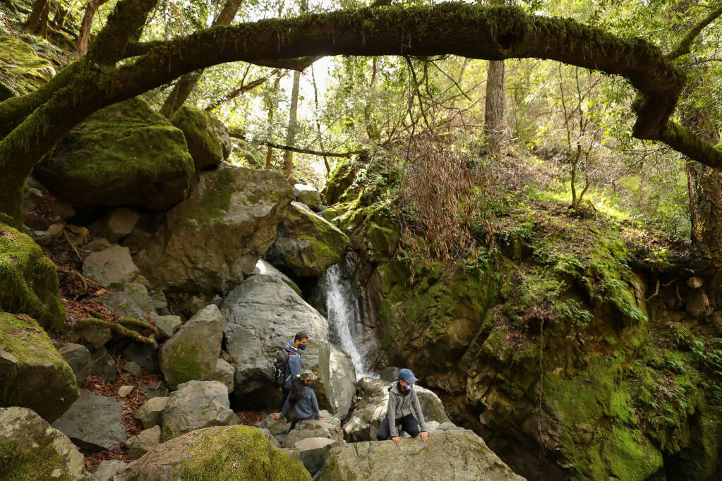 Shyam Nagasrinivasa, left, explores the waterfall along the Canyon Trail with Dhruti, 7, and Dhruva Kaashyap, 10, in Sugarloaf Ridge State Park near Kenwood. Join a 5-mile guided hike at Sugarloaf on May 28 to learn about dragonflies and butterflies and their habitats. (Christopher Chung/ The Press Democrat)