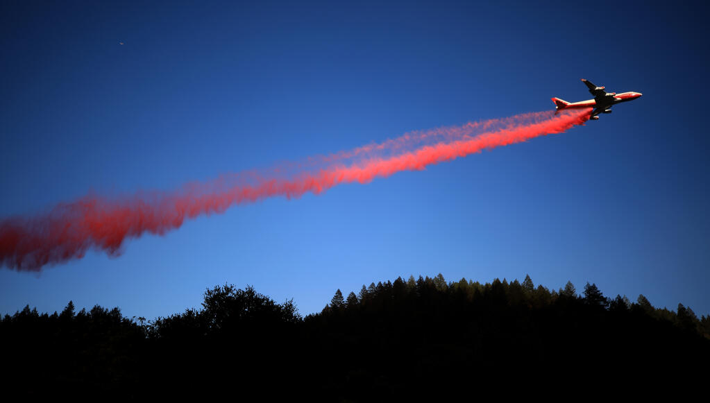 The Global Super Airtanker drops a contingency line of retardant on the Glass fire near Sanitarium Road, Sunday, Sept. 27, 2020 in the Napa Valley. (Kent Porter / The Press Democrat) 2020