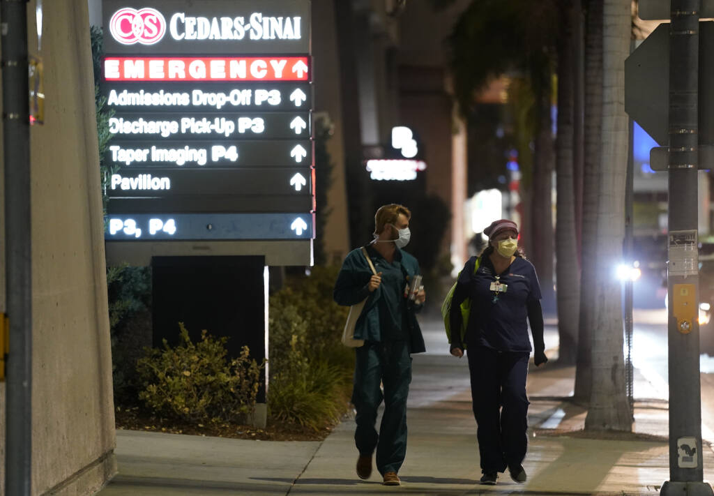 FILE - In this Jan. 5, 2021, file photo, Cedars-Sinai Medical Center workers walk outside the hospital, in Los Angeles. The California Senate has rejected a bill aimed at making it easier for some hospital workers to get workers compensation benefits. (AP Photo/Chris Pizzello,File)