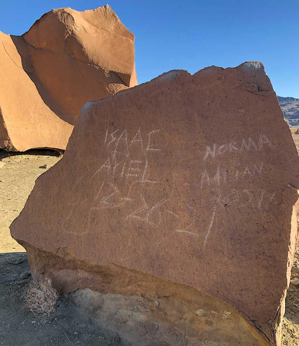 In an undated image provided by the National Park Service, vandalism on a rock at Big Bend National Park in Texas. Abstract geometric designs at Big Bend National Park in Texas that had survived for thousands of years were “irreparably damaged” by vandals who scratched names and dates into the prehistoric designs, the National Park Service said. (National Park Service via The New York Times)