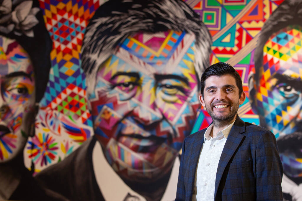 Glaydon de Freitas, newly appointed CEO of Corazon Healdsburg, poses for a portrait in front of a mural featuring artist Frida Kahlo, civil rights leader César Chávez and Mexican Revolutionary leader Emiliano Zapata at the nonprofit organization's headquarters in Healdsburg on Thursday, Nov. 5, 2020. (Alvin A.H. Jornada / The Press Democrat)