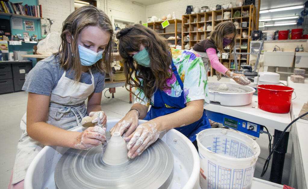 Lexi Bakkar, ceramics studio coordinator and youth program manager, helps Gligi Vaio, 9, with her ceramics project at an art class in the ceramics room at the Sonoma Community Center on Thursday, Oct. 28, 2021, one of many art education options for Sonoma youth. (Photo by Robbi Pengelly/Index-Tribune)