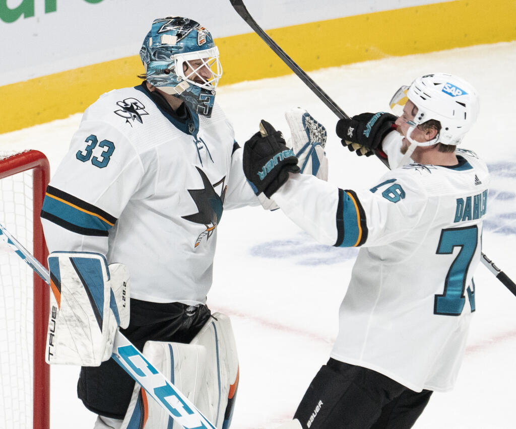 San Jose Sharks goaltender Adin Hill, left, celebrates with Jonathan Dahlen after shutting out the Montreal Canadiens on Tuesday, Oct. 19, 2021, in Montreal. (Ryan Remiorz / Canadian Press)
