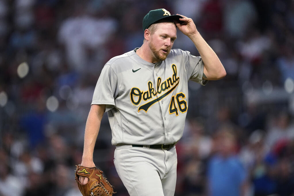 Oakland Athletics pitcher Jared Koenig adjusts his cap as he leaves the field after being removed during the fifth inning against the Braves on Wednesday, June 8, 2022, in Atlanta. (John Bazemore / ASSOCIATED PRESS)