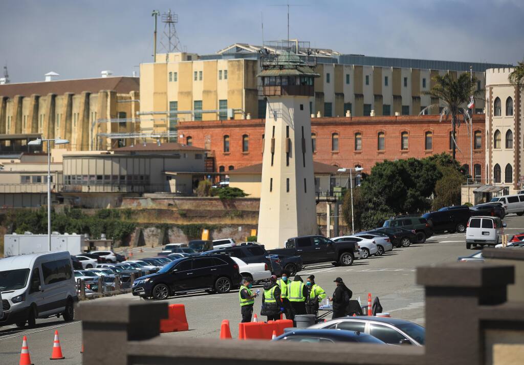 Medical personnel are staged just inside the gate of San Quentin State Prison for screening and temperature checks for those coming into the prison for business, Thursday, July 16, 2020, in San Quentin. (Kent Porter / The Press Democrat) 2020