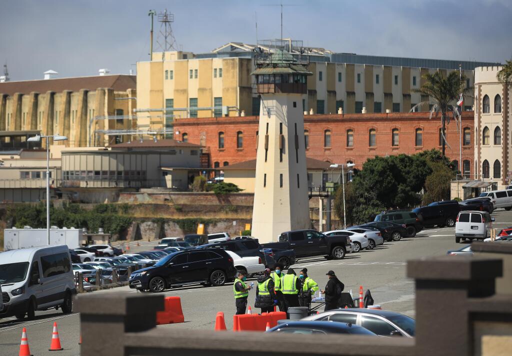 Medical personnel are staged just inside the gate of San Quentin State Prison for screening and temperature checks for those coming in to the prison for business, Thursday, July 16, 2020 in San Quentin. (Kent Porter / The Press Democrat) 2020