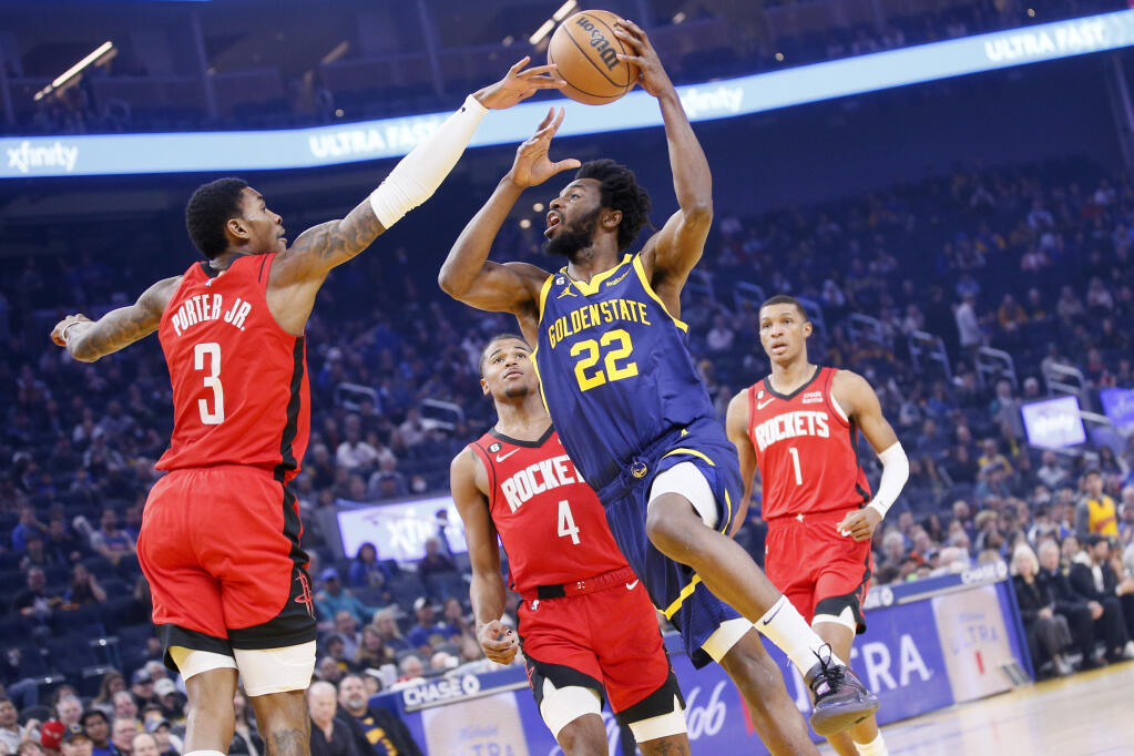 Golden State Warriors forward Andrew Wiggins handles the ball against Houston Rockets guard Kevin Porter Jr. in the first quarter Saturday in San Francisco. (Santiago Mejia / San Francisco Chronicle)