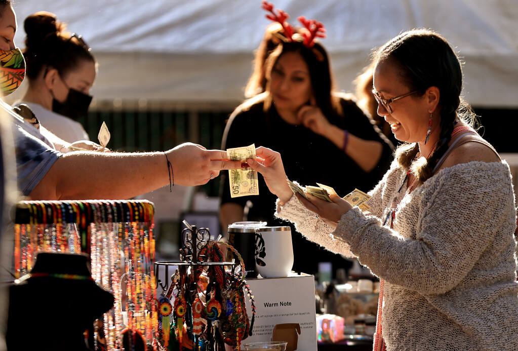 Shanna Zepeda of Sebastopol sells Indigenous creations from a family member in Mexico, through her business Calendula.  The Juncture Taproom in Santa Rosa hosts a Holiday Gift and Craft Fair to benefit the nonprofit Small Business Hardship Fund, Saturday, Nov. 27, 2021 in Santa Rosa. (Kent Porter / The Press Democrat) 2021