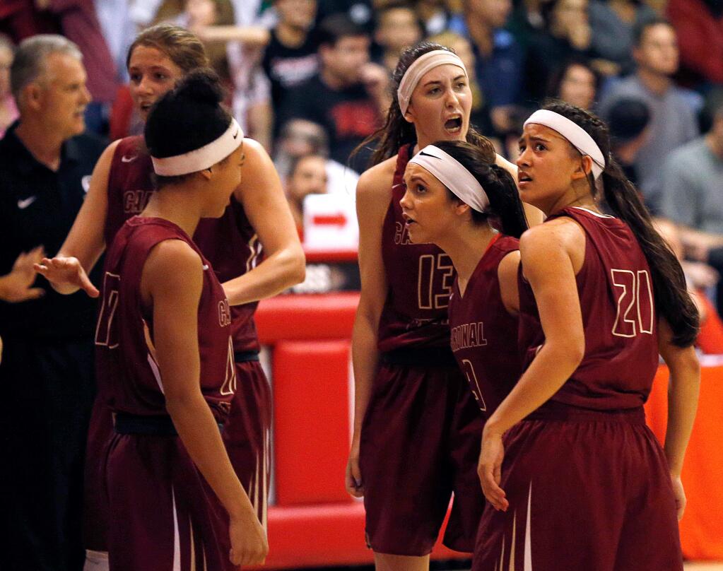Cardinal Newman's Avery Cargill (21), right, Maiya Flores (3), Hailey Vice-Neat (13), Anya Choice (10), and Lauren Walker (44) huddle up during the CIF State Girls Basketball Open Division first-round playoff game between Cardinal Newman and Carondelet on Friday, March 10, 2017. (Alvin Jornada / The Press Democrat)