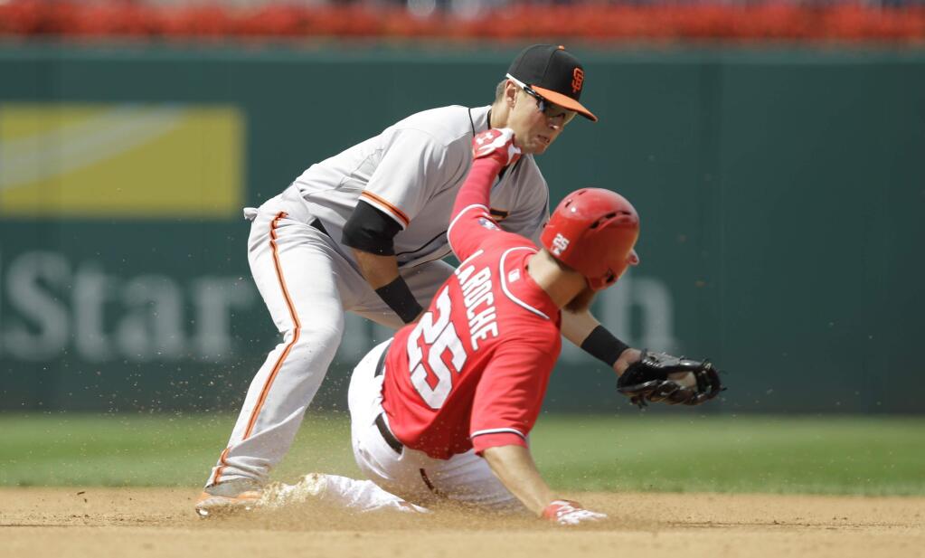 Washington Nationals' Adam LaRoche (25) slides safely into second base on his RBI doubled that scored Washington Nationals Jayson Werth as San Francisco Giants second baseman Joe Panik, left, attempt the tag during the fourth inning of a baseball game, Sunday, Aug. 24, 2014, in Washington. The Nationals won 14-6. (AP Photo/Luis M. Alvarez)