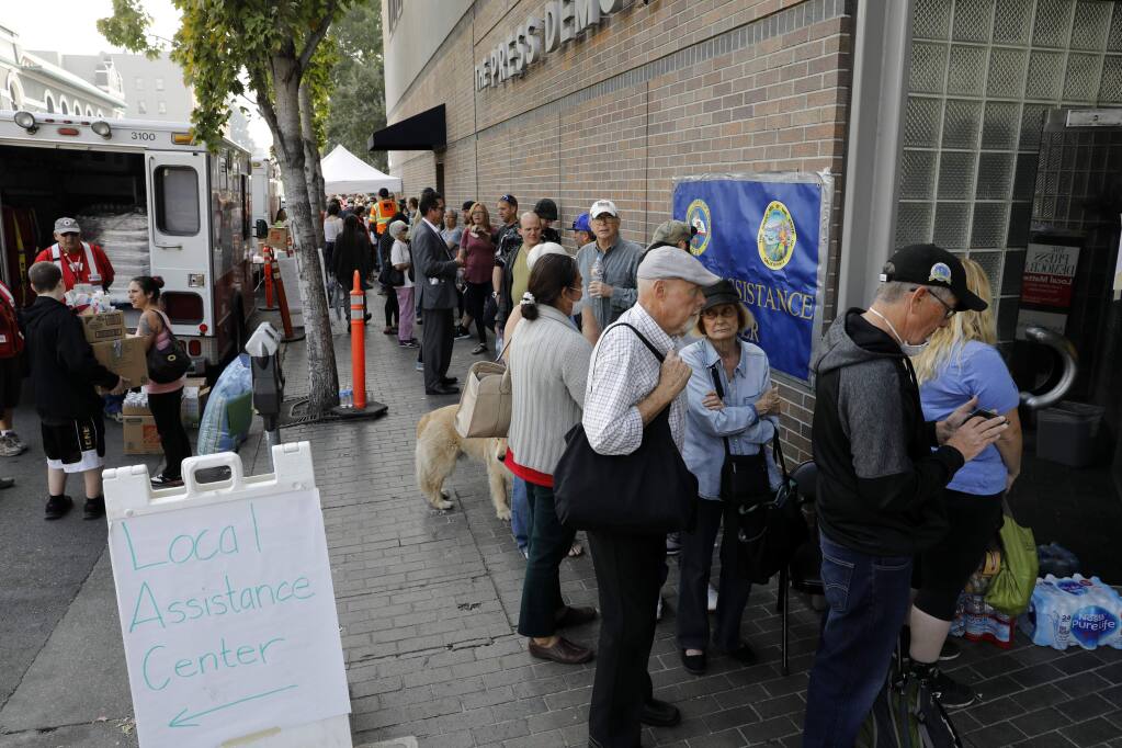 People line up outside the FEMA hub at 427 Mendocino Avenue in Santa Rosa on Monday, October 16, 2017. (BETH SCHLANKER/ The Press Democrat)