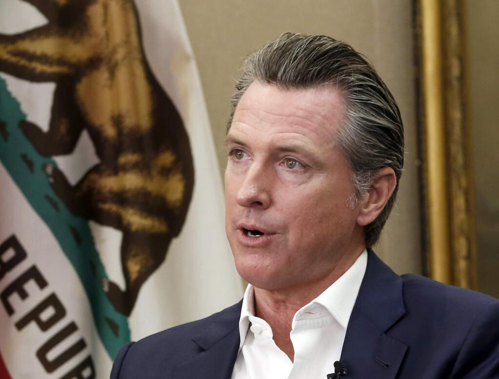 FILE - This Oct. 8, 2019, file photo, shows California Gov. Gavin Newsom during an interview in his office at the Capitol in Sacramento, Calif. California's Supreme Court rejected a state law that would have required President Donald Trump to disclose his tax returns to appear as a candidate in the state's primary election next spring. The justices on Thursday, Nov. 21, 2019 said the law that would have required tax returns for all presidential and gubernatorial candidates to appear on the primary ballot was unconstitutional. The state Republican Party challenged the bill signed into law by Newsom because it was aimed at Trump. (AP Photo/Rich Pedroncelli, File)