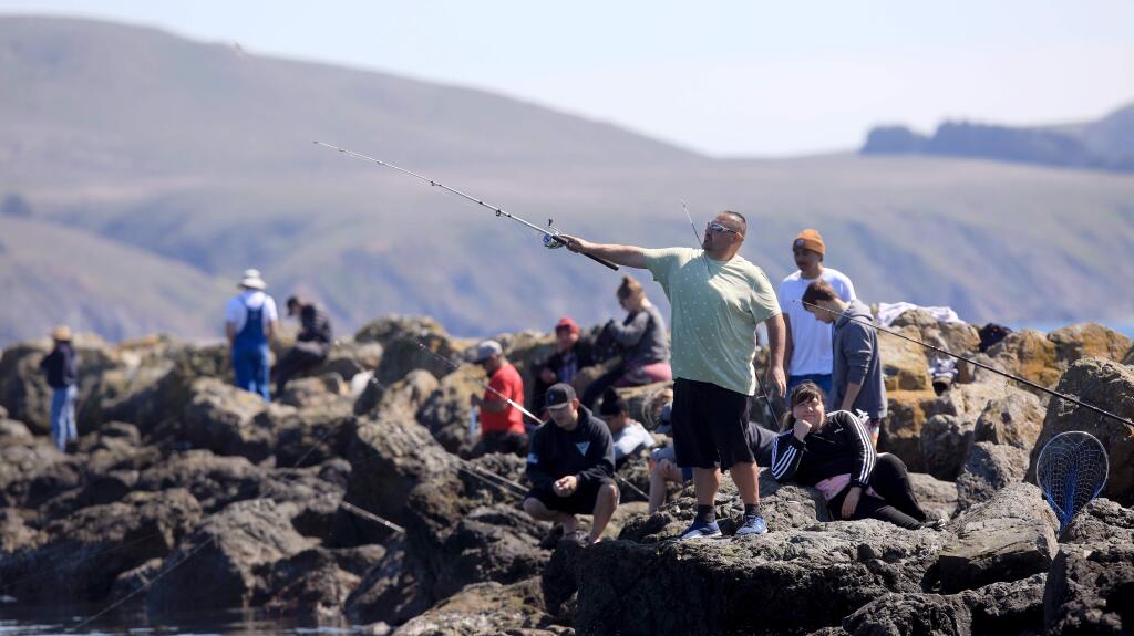 The jetties in Bodega Bay were popular with fisherman, Saturday, March 21, 2020 as Sonoma County residents crowded coastal beaches after five days of sheltering in place in response to the COVID-19 pandemic. (Kent Porter / The Press Democrat) 2020