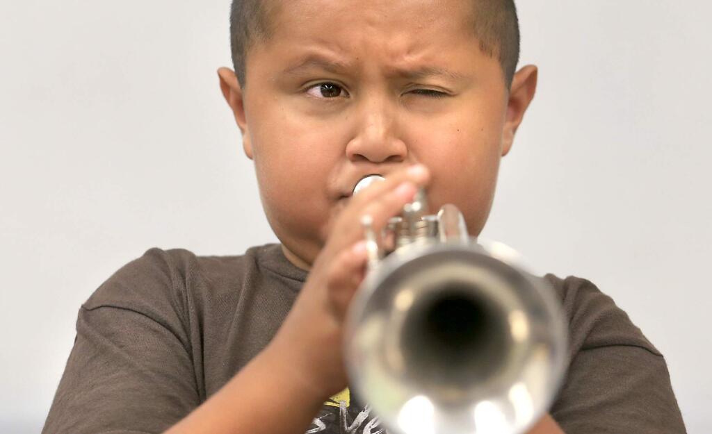 Oliver Cruz, 9, hits a high note as he practices trumpet during mariachi camp at Cook Middle School in Santa Rosa on Monday, July 27, 2015. (KENT PORTER/ PD)