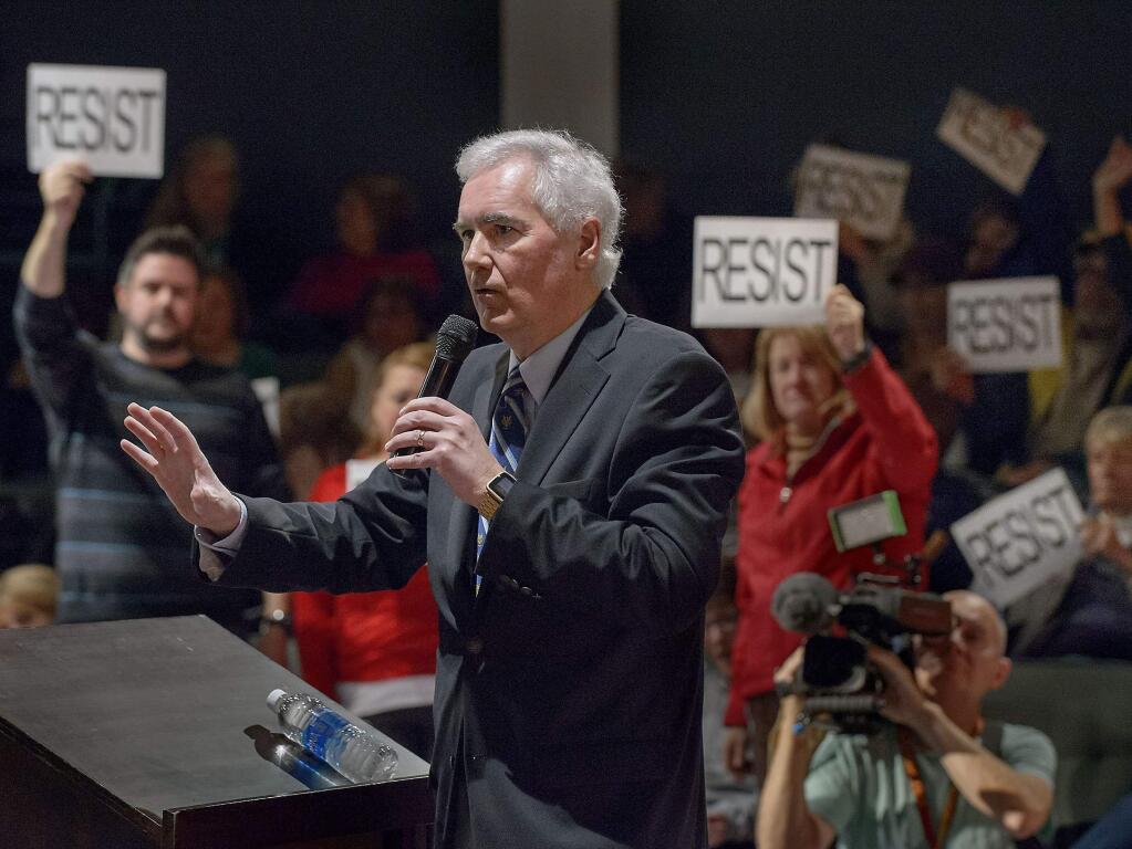 Congressman Tom McClintock, R-Calif., fields questions from an audience at the Tower Theatre in Roseville, Calif., Saturday, Feb. 4, 2017. McClintock on Saturday faced the rowdy crowd at the packed town hall meeting in Northern California, and had to be escorted by police as protesters followed him shouting 'Shame on you!' (Randall Benton/The Sacramento Bee via AP)