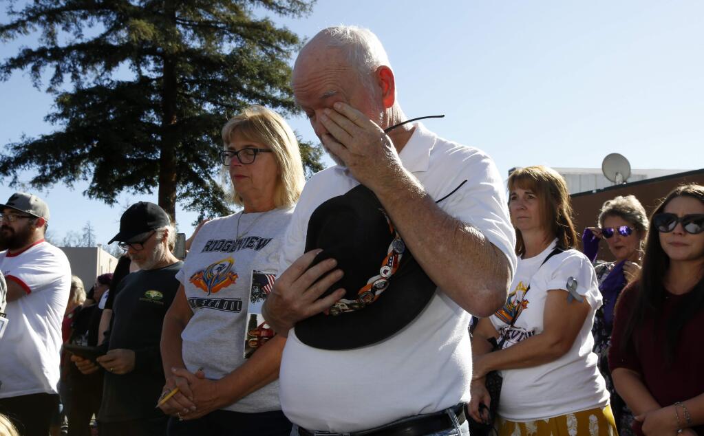 Mike Greer wipes his eyes during the 85 seconds of silence honoring the 85 people who died in last year's Camp Fire during ceremonies in Paradise, Calif., Friday, Nov. 8, 2019. Friday marks the one year anniversary of the wildfire that nearly destroyed the entire town of Paradise. (AP Photo/Rich Pedroncelli)