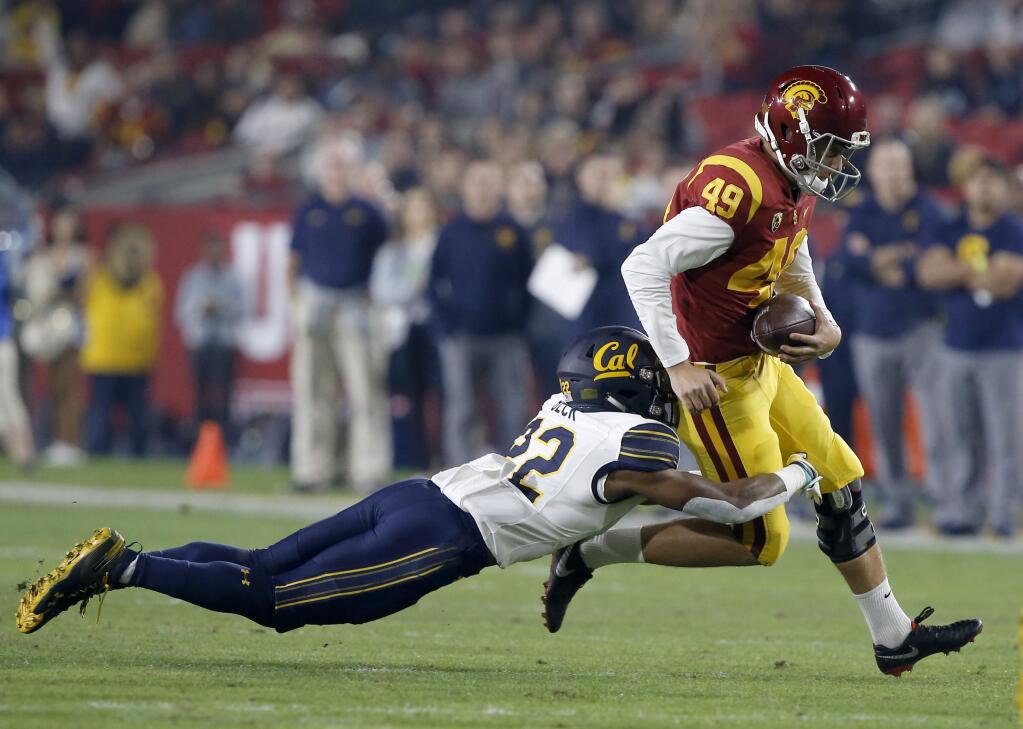USC kicker Michael Brown, right, is pulled down by Cal's Traveon Beck, left, on a fake field goal during the first half in Los Angeles, Saturday, Nov. 10, 2018. (AP Photo/Alex Gallardo)