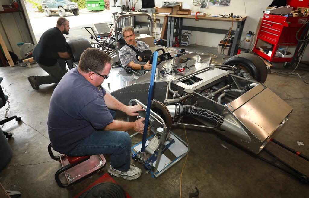 Photos by John Burgess / The Press DemocratSean Inglesby, from left, Ilja Burkoff and Jordan Coomrad build a Ti 22 MK II based on the Can-Am race series from 1966-1974 in their Santa Rosa garage.