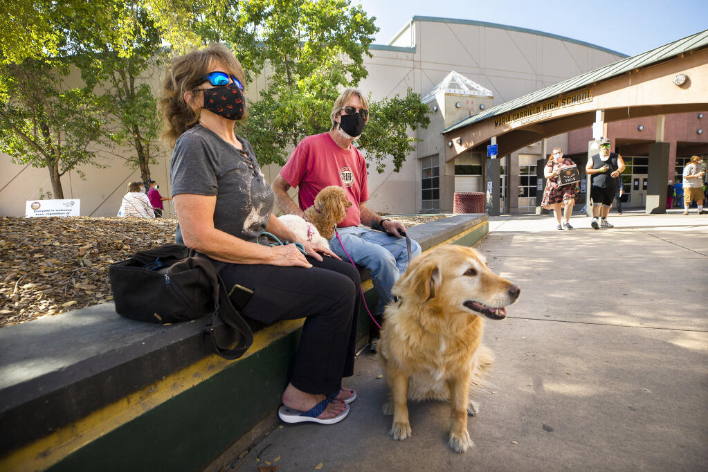 Carolyn and Ken Campbell brought their three dogs to the Sonoma County and Santa Rosa city assistance center at Maria Carrillo High School hoping to find out when they can return to their evacuated home off Los Alamos Road. On Monday, October 5, 2020.   (Photo by John Burgess/The Press Democrat)