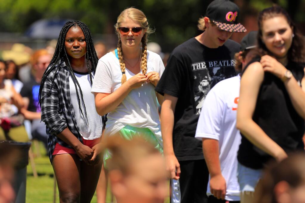 Santa Rosa High school senior Deborah Fry, far left, waits for her name to be called during graduation practice on Wednesday. Fry will graduate with her class on Friday rather than go the the state track meet in the shot put. (JOHN BURGESS/The Press Democrat)