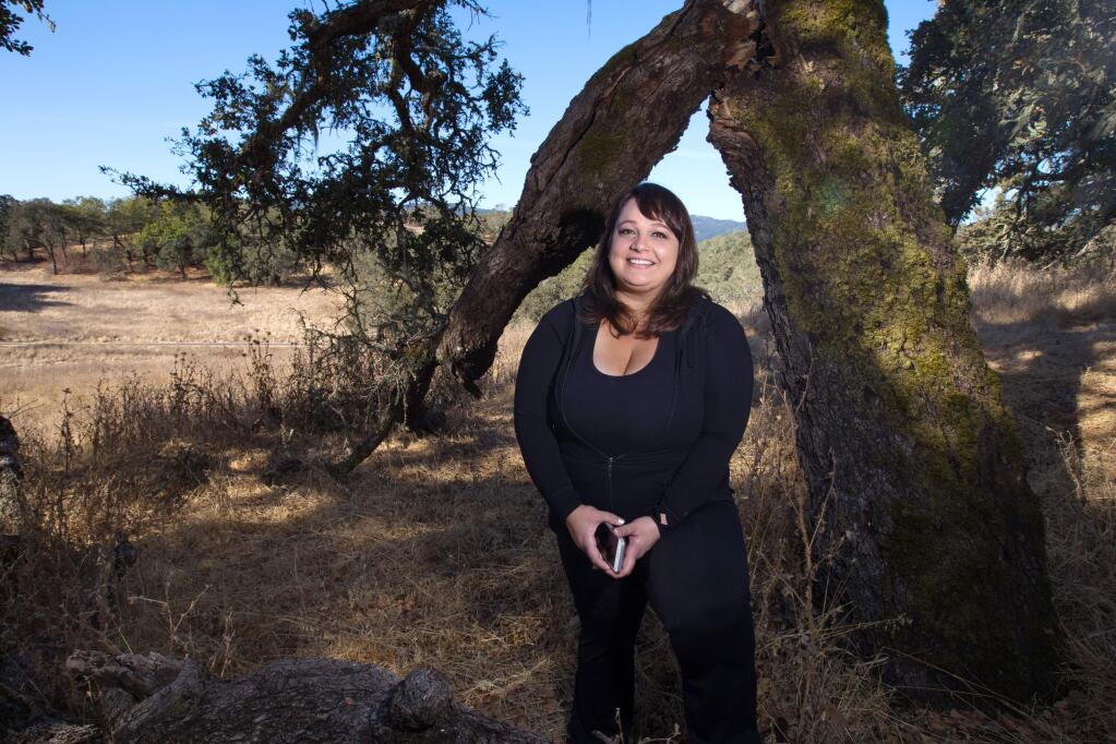 Frequent visitor, Jennielynn Holmes of Santa Rosa, stands near a tree in Sonoma Valley Regional Park, in Glen Ellen, on Saturday, September 30, 2017. (Photo by Darryl Bush / For The Press Democrat)