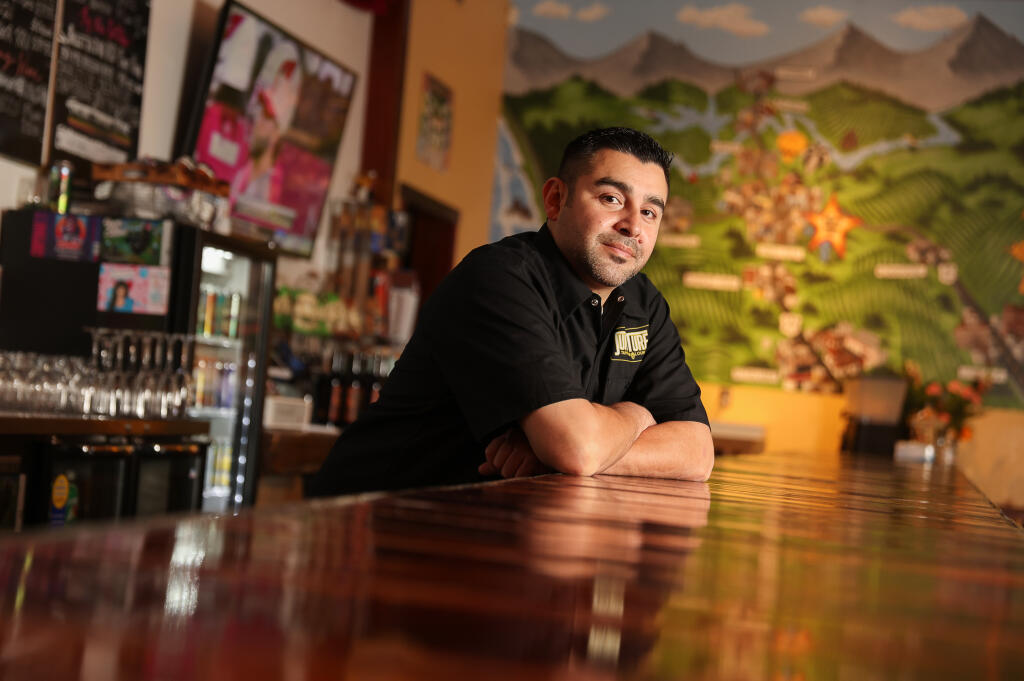 Peter Lopez Jr., owner of Juncture Taproom & Lounge, has seen his business through wildfires, power outages and pandemic closures.  Photo taken in Santa Rosa on Monday, Dec. 12, 2022.  (Christopher Chung / The Press Democrat file)