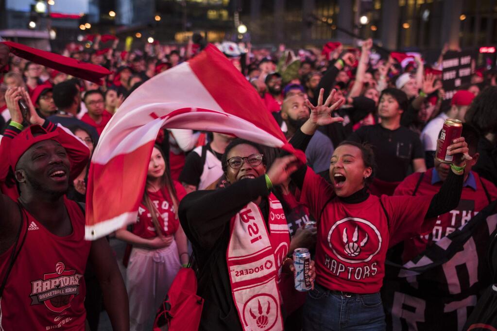 Toronto Raptors fans sing the Canadian national anthem outside Scotiabank Arena before Game 1 of the NBA Finals between the Golden State Warriors and the Raptors in Toronto on Thursday, May 30, 2019. (Tijana Martin/The Canadian Press via AP)
