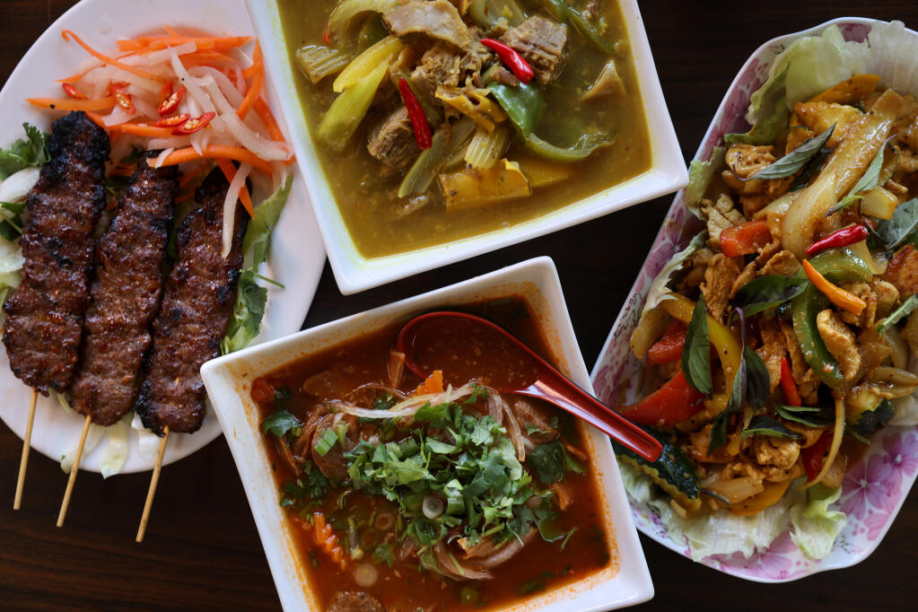 (Clockwise from top) Cambodian style dishes including Somlaor Machu Kreung (sour beef soup), stir fried lemongrass chicken, beef stew and beef skewers on Thursday, April 28, 2022, at Tan's Donut in Santa Rosa. (Beth Schlanker / The Press Democrat)