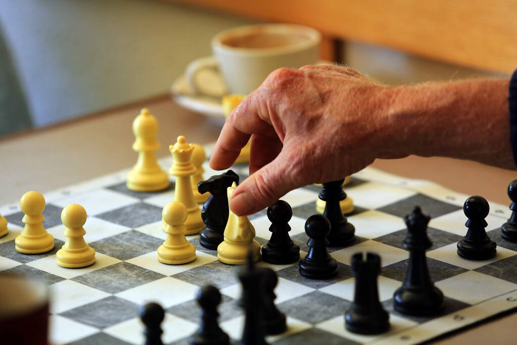 -Bruce Wishard takes Ed Colletti's rook during a match last month at SoCo Coffee in Santa Rosa. Chess players regularly gather at the coffeehouse for pickup games.
