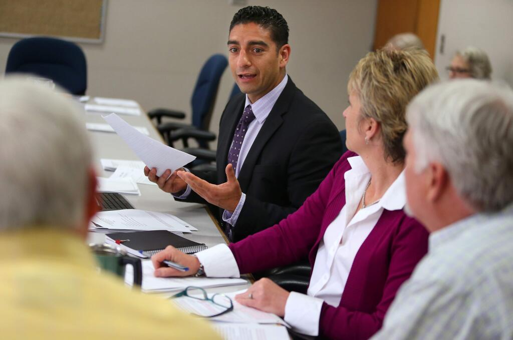 Sonoma County Supervisor Efren Carrillo, center, talks during a Roseland Annexation Subcommittee meeting, with Assistant City Manager Jennifer Phillips, Assistant City Manager and Community Development Director Chuck Regalia, and Santa Rosa Mayor Scott Bartley, left, at Santa Rosa City Hall on Thursday, May 8, 2014. (Christopher Chung/ The Press Democrat)