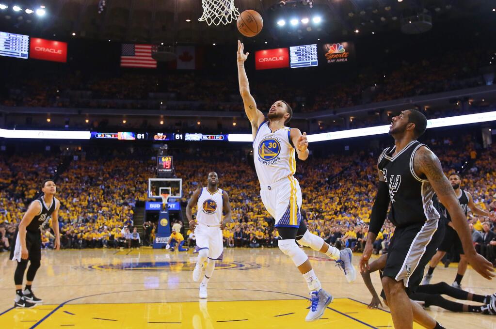 Golden State Warriors guard Stephen Curry lays the ball in against the San Antonio Spurs, during Game 2 of the NBA Western Conference Finals in Oakland on Tuesday, May 16, 2017. The Warriors defeated the Spurs 136-100.(Christopher Chung/ The Press Democrat)