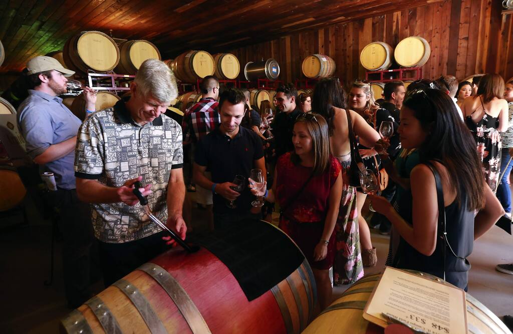 Wine lovers attend the 37th Annual Wine Road Barrel Tasting in 2015. Sonoma County planning officials have been crafting proposed regulations that could set new standards for winery development and events since that year; the process is ongoing. (JOHN BURGESS/ PD FILE, 2015)