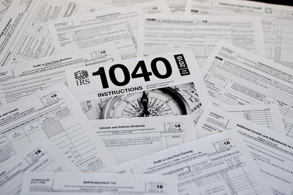 This Feb. 13, 2019, photo shows multiple forms printed from the Internal Revenue Service web page that are used for 2018 U.S. federal tax returns in Zelienople, Pa. The head of the IRS, overseeing the most sweeping overhaul of the U.S. tax codes in three decades, says the average refund in this year's tax-filing season, $2,833, worked out to be close to last year's. Internal Revenue Service Commissioner Charles Rettig told Congress Wednesday that an increase is urgently needed in the agency's budget to modernize antiquated computer systems and protect taxpayers' data. (AP Photo/Keith Srakocic)