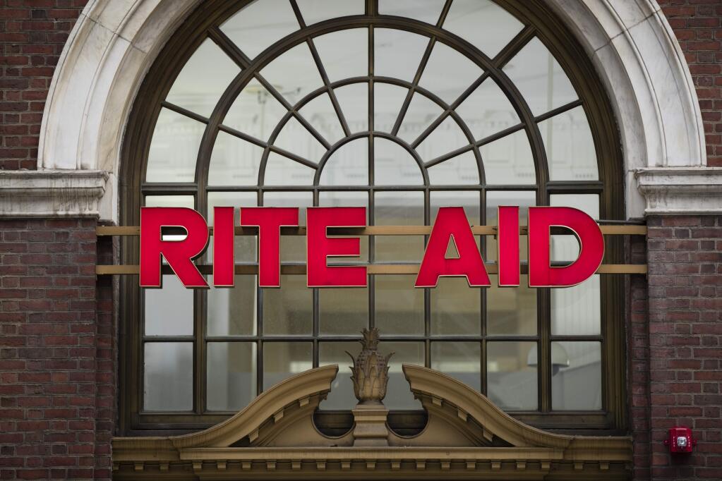 FILE - This Oct. 21, 2016 file photo shows a Rite Aid location in Philadelphia. The privately held owner of Safeway, Vons and other grocery brands is plunging deeper into the pharmacy business with a deal to buy Rite Aid, the nation's third-largest drugstore chain. Albertsons Companies is offering either a share of its stock and $1.83 in cash or slightly more than a share for every 10 shares of Rite Aid. A deal value was not disclosed in a statement released Tuesday, Feb. 20, 2018, by the companies. (AP Photo/Matt Rourke)