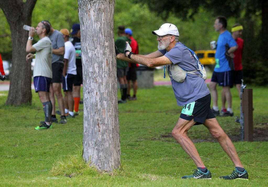 Jerry Kibler of Petaluma stretches before the start of the he Annadel Half Marathon and 5K on Saturday, April 11, 2015. (Photo by John Burgess)