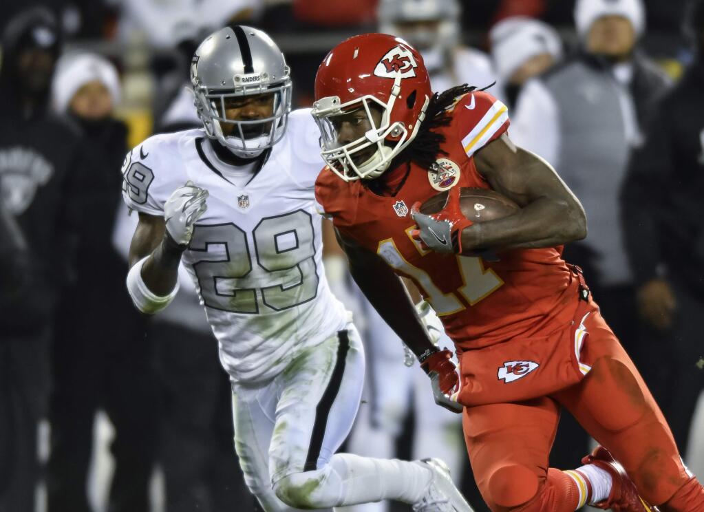 Kansas City Chiefs wide receiver Chris Conley (17) makes a catch in front of Oakland Raiders cornerback David Amerson (29) during the first half Sunday, Oct. 23, 2016. (AP Photo/Reed Hoffmann)