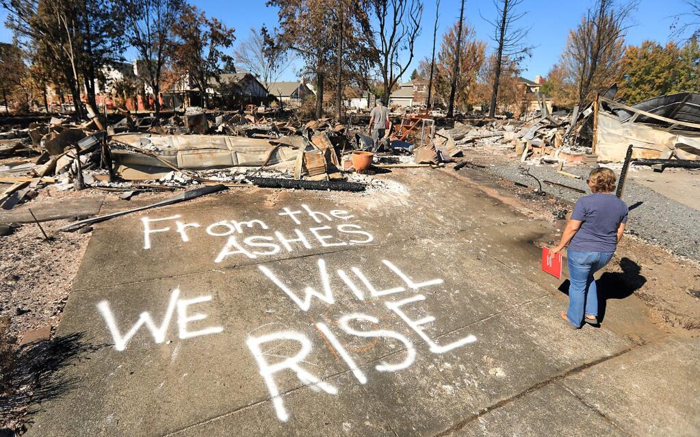 At Coffey Park in Santa Rosa, Traci Lattie and her partner Wayne Hovey intend to rebuild, and are letting everyone know, Monday Oct. 23, 2017. On Monday they met with their insurance agent. (Kent Porter / Press Democrat) 2017