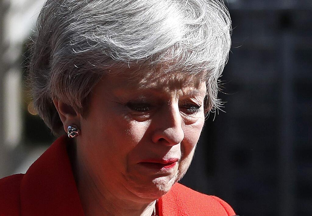 British Prime Minister Theresa May reacts as she turns away after making a speech in the street outside 10 Downing Street in London, England, Friday, May 24, 2019. Theresa May says she'll quit as UK Conservative leader on June 7, sparking contest for Britain's next prime minister. (AP Photo/Alastair Grant)
