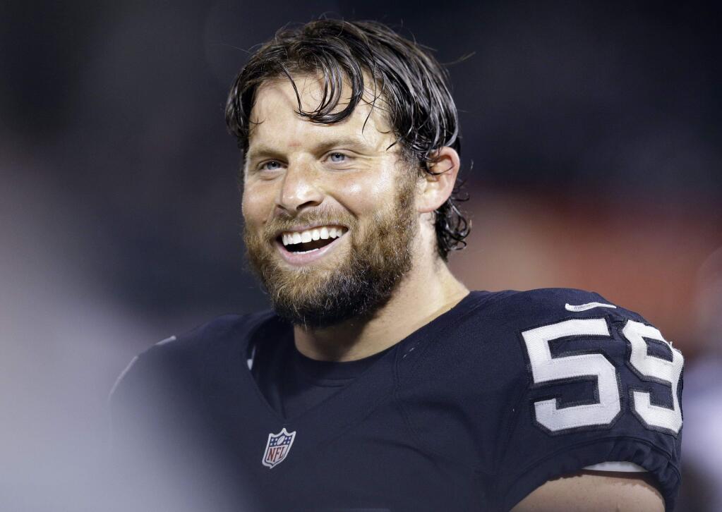 Oakland Raiders' Jon Condo (59) smiles from the sideline during the second half of a preseason NFL football game against the Seattle Seahawks Thursday, Sept. 1, 2016, in Oakland, Calif. (AP Photo/Ben Margot)
