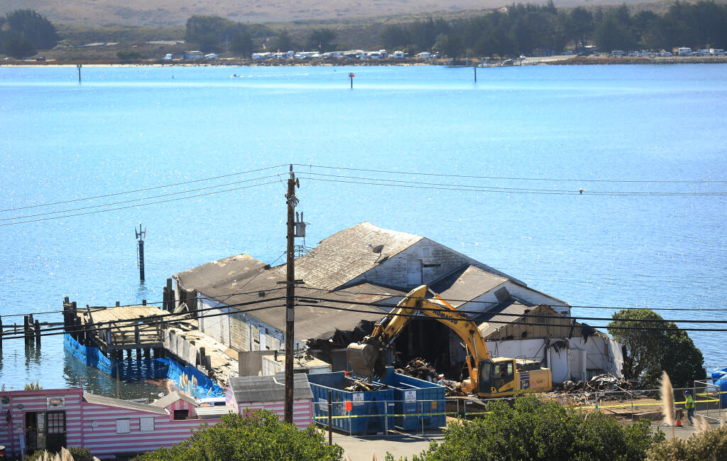 A construction crew begins the demolition of the Meredith Pier, Friday, Oct. 16, 2020 in Bodega Bay. (Kent Porter / The Press Democrat)