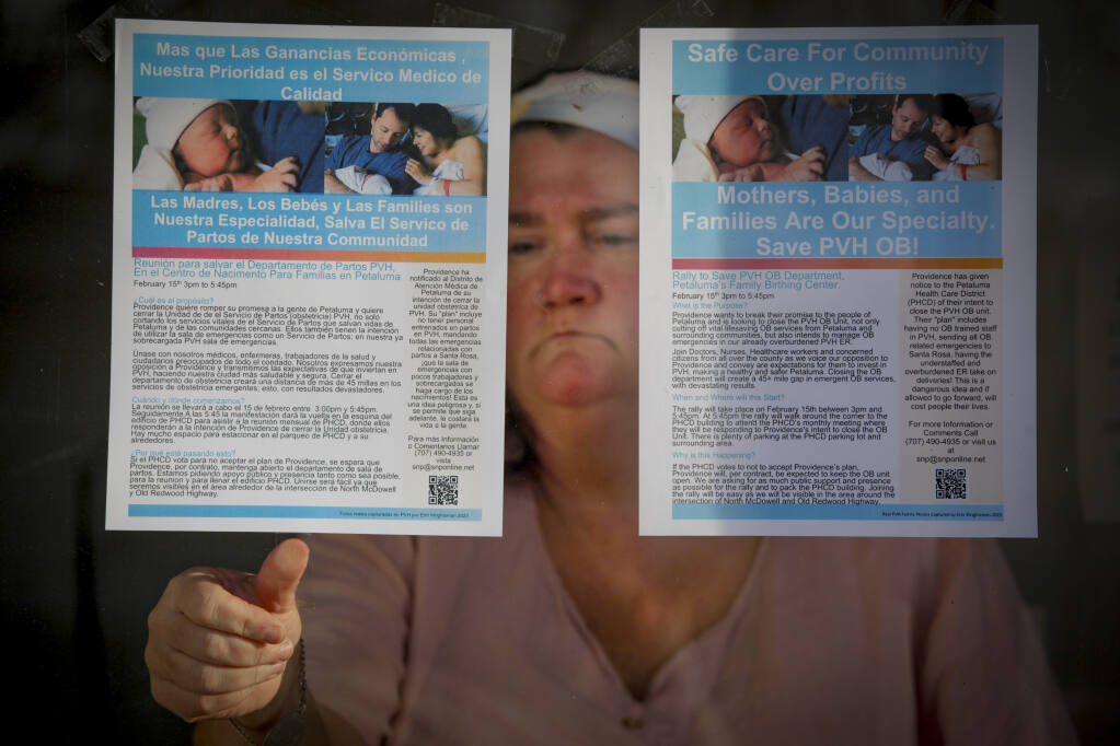 Denise Cobb hangs flyers for a rally she is organizing to stop Petaluma Valley Hospital from closing down its maternity ward._Wednesday, February 01, 2023._(CRISSY PASCUAL/ARGUS-COURIER STAFF)